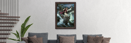 A modern living room with a gray sectional sofa, brown and gray pillows, a large framed painting of a figure on a boat in stormy seas, and a green plant near a staircase with vertical railings.